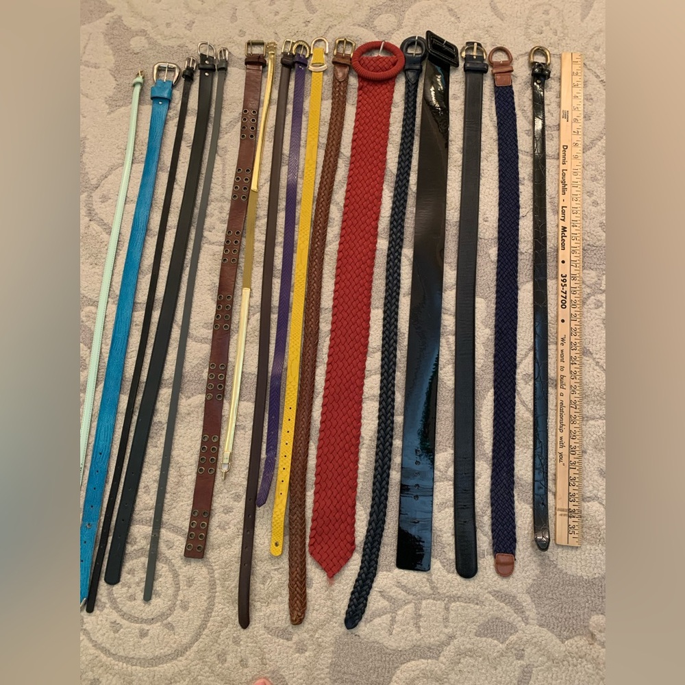 Assortment of Women’s belts. Various colors. See yard stick to show length.